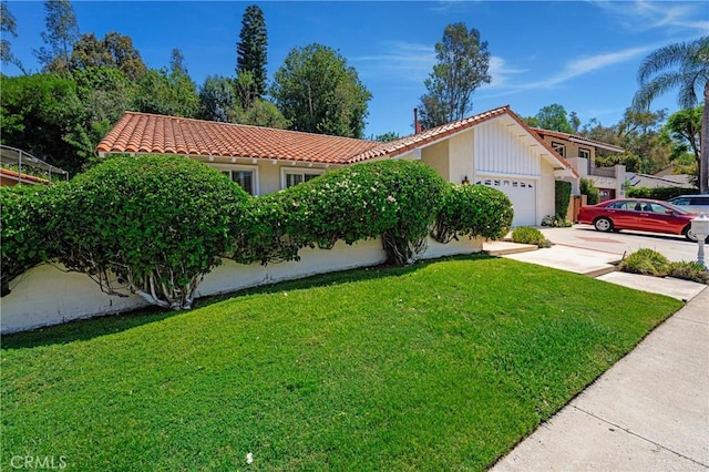26501 Cortina Dr, Mission Viejo, CA 92691 - view of front facade featuring an attached garage, a tile roof, a front yard, and stucco siding