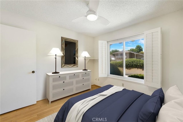 26501 Cortina Dr, Mission Viejo, CA 92691 - bedroom featuring wood finished floors, a textured ceiling, and ceiling fan
