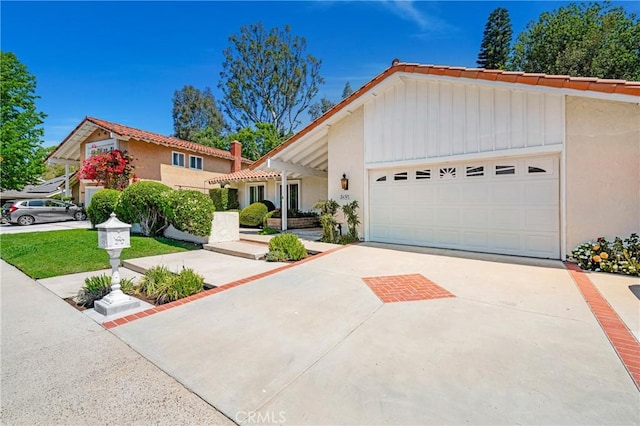26501 Cortina Dr, Mission Viejo, CA 92691 - view of front of property with an attached garage, concrete driveway, stucco siding, and a tiled roof