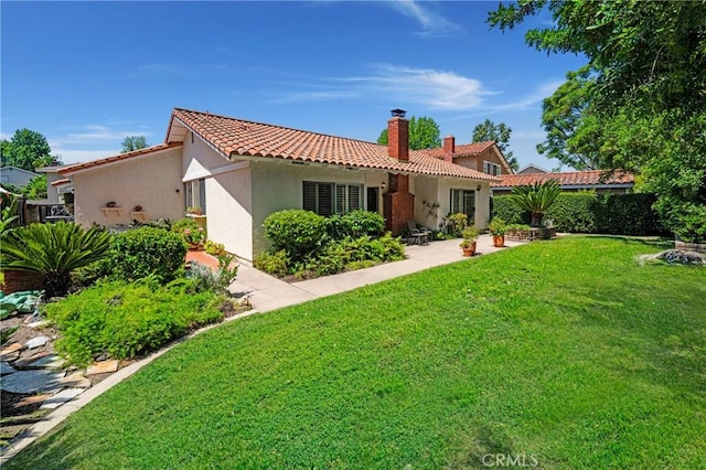 26501 Cortina Dr, Mission Viejo, CA 92691 - back of house with a tile roof, stucco siding, and a chimney