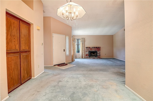 5050 Canyon Crest Dr Unit 5, Riverside, CA 92507 - carpeted foyer entrance with a chandelier and a fireplace