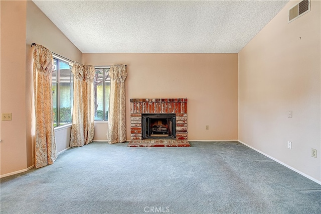 5050 Canyon Crest Dr Unit 5, Riverside, CA 92507 - unfurnished living room with a textured ceiling, carpet floors, and a fireplace