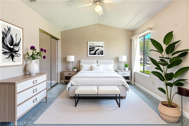 5050 Canyon Crest Dr Unit 5, Riverside, CA 92507 - carpeted bedroom with vaulted ceiling, a textured ceiling, ceiling fan, and a closet