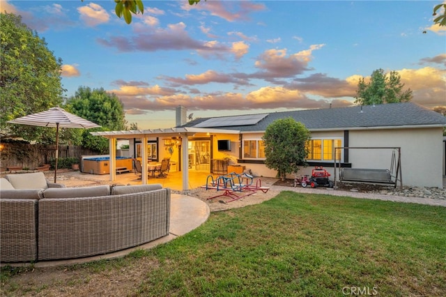 2240 La Sierra Way, Claremont, CA 91711 - back of house at dusk featuring outdoor lounge area, a hot tub, a patio area, solar panels, and a fenced backyard