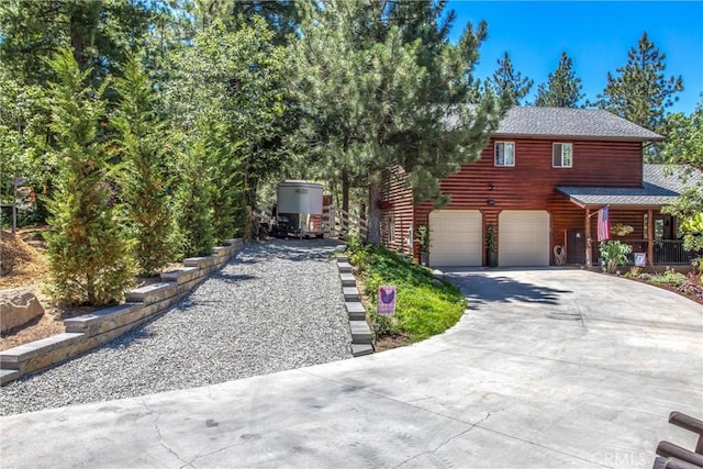 32425 Snowshoe Ln, Running Springs, CA 92382 - view of front of house with concrete driveway and a garage