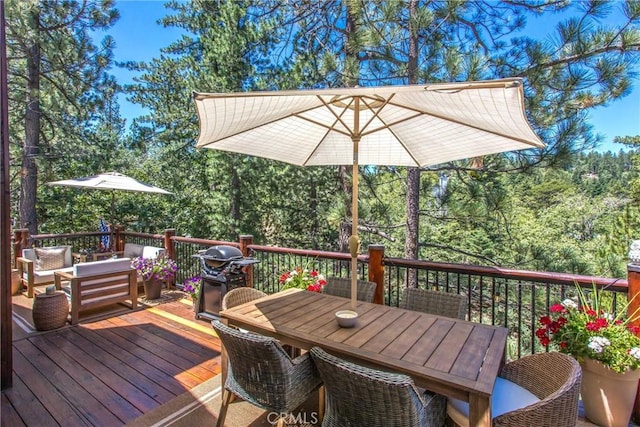 32425 Snowshoe Ln, Running Springs, CA 92382 - deck featuring a grill, outdoor dining space, and outdoor lounge area
