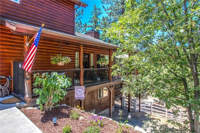 32425 Snowshoe Ln, Running Springs, CA 92382 - view of home's exterior featuring faux log siding and a chimney