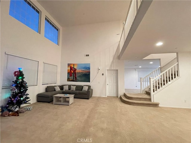 12639 Spruce Hill Rd, Moreno Valley, CA 92555 - living room featuring carpet flooring, stairs, and a towering ceiling