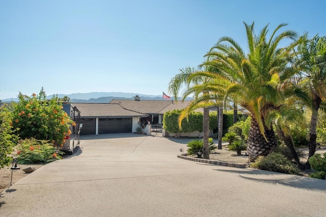 1524 Zutano Ln, Fallbrook, CA 92028 - view of front facade with an attached garage, driveway, a tiled roof, and a mountain view
