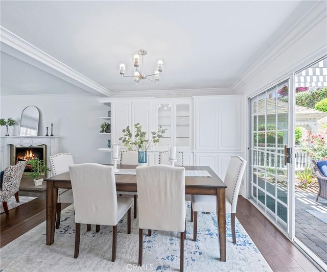 415 Buttonwood Dr, Brea, CA 92821 - dining room with a chandelier, wood finished floors, crown molding, and a lit fireplace