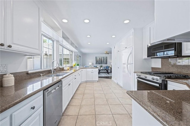 415 Buttonwood Dr, Brea, CA 92821 - kitchen with stainless steel appliances, recessed lighting, white cabinetry, light tile patterned floors, and decorative backsplash