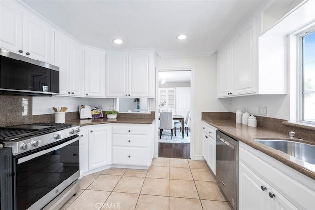 415 Buttonwood Dr, Brea, CA 92821 - kitchen with stainless steel appliances, white cabinets, dark countertops, light tile patterned floors, and recessed lighting