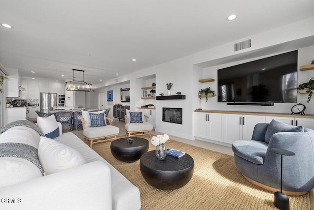 1437 Windshore Way, Oxnard, CA 93035 - living room featuring recessed lighting, built in features, and a glass covered fireplace