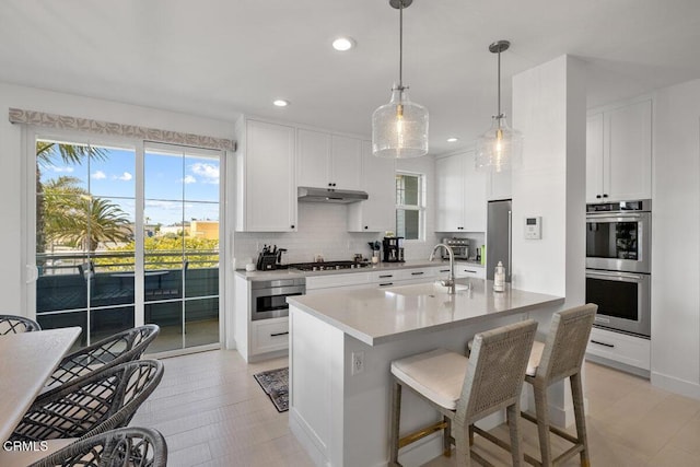 1437 Windshore Way, Oxnard, CA 93035 - kitchen with stainless steel appliances, decorative backsplash, healthy amount of natural light, under cabinet range hood, and recessed lighting