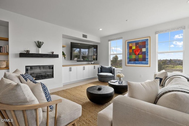 1437 Windshore Way, Oxnard, CA 93035 - living area with healthy amount of natural light, a glass covered fireplace, recessed lighting, and light wood-type flooring