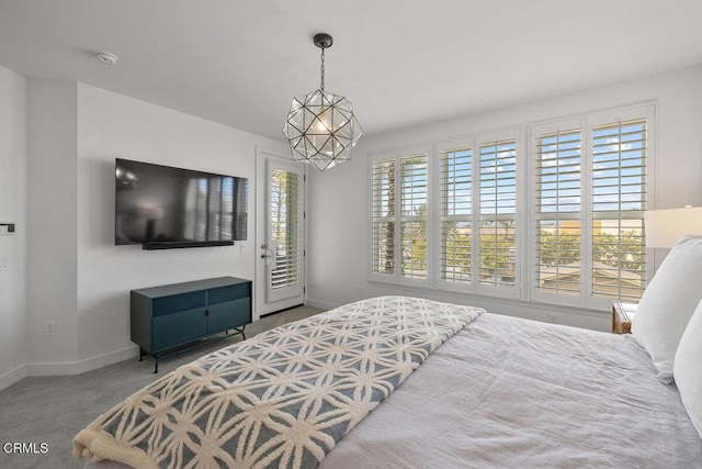 1437 Windshore Way, Oxnard, CA 93035 - carpeted bedroom with access to exterior, multiple windows, and a chandelier