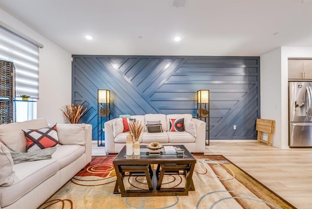 5261 Beachfront Cove St # 174, San Diego, CA 92154 - living room with an accent wall, wood finished floors, and recessed lighting