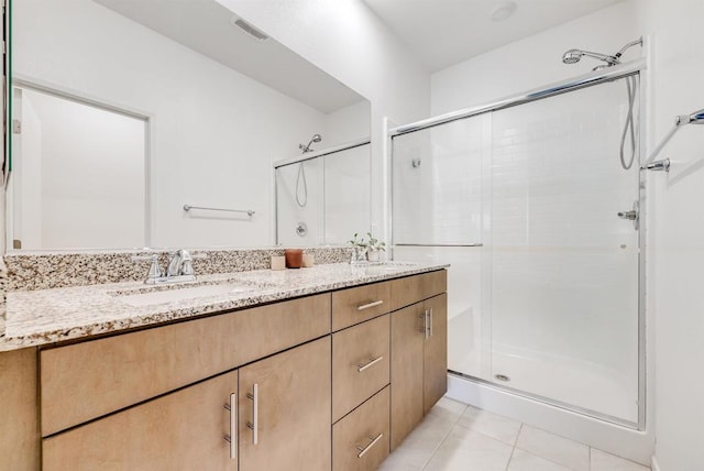 5261 Beachfront Cove St # 174, San Diego, CA 92154 - full bath with a stall shower, double vanity, and tile patterned floors