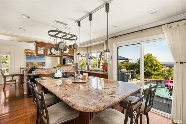 3602 E Ridgeway Rd, Orange, CA 92867 - kitchen featuring gas stovetop, light wood-style floors, a center island, light stone counters, and recessed lighting