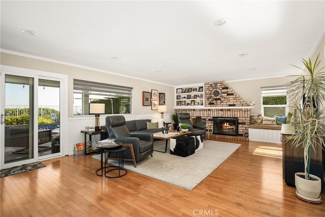 3602 E Ridgeway Rd, Orange, CA 92867 - living room featuring hardwood / wood-style floors, a brick fireplace, and crown molding