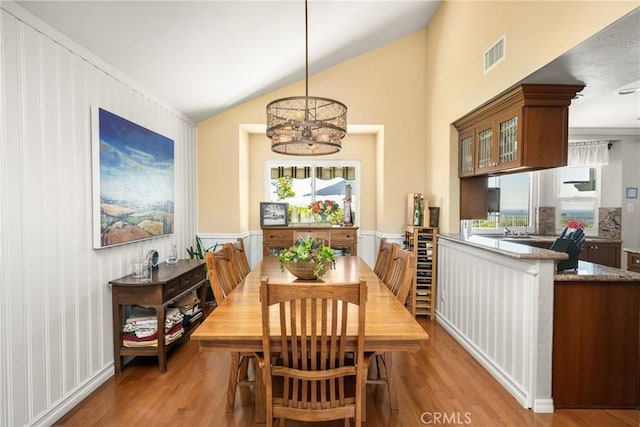 3602 E Ridgeway Rd, Orange, CA 92867 - dining space featuring plenty of natural light, wood finished floors, lofted ceiling, and a chandelier