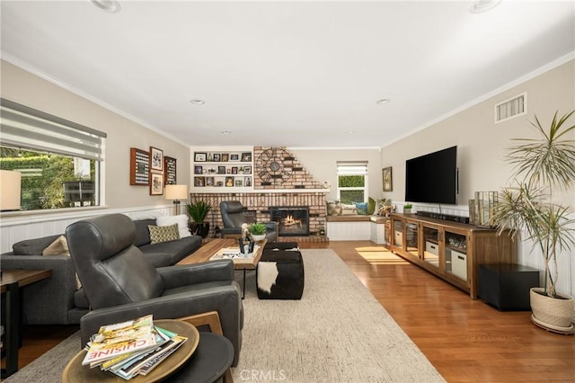3602 E Ridgeway Rd, Orange, CA 92867 - living room with wood finished floors, a brick fireplace, ornamental molding, and built in features