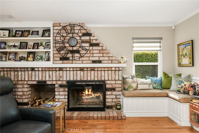 3602 E Ridgeway Rd, Orange, CA 92867 - living area with a fireplace, wood finished floors, and ornamental molding