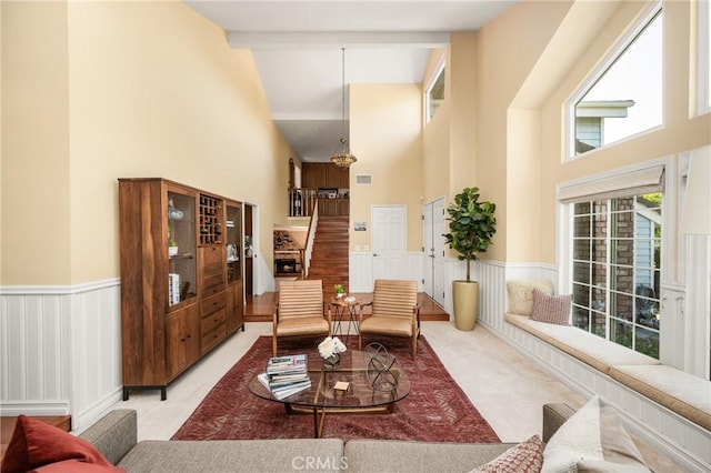 3602 E Ridgeway Rd, Orange, CA 92867 - living area with high vaulted ceiling, stairs, a wainscoted wall, and beamed ceiling