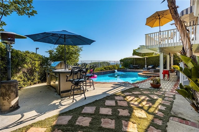 3602 E Ridgeway Rd, Orange, CA 92867 - view of swimming pool with a patio, a fenced backyard, a pool with connected hot tub, area for grilling, and exterior bar