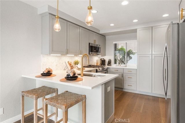 29416 Port Royal Way, Laguna Niguel, CA 92677 - kitchen with stainless steel appliances, a peninsula, dark wood-type flooring, tasteful backsplash, and recessed lighting