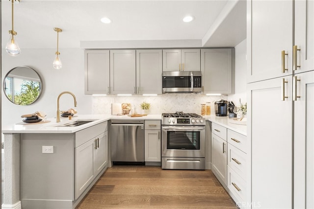 29416 Port Royal Way, Laguna Niguel, CA 92677 - kitchen with stainless steel appliances, gray cabinets, a peninsula, decorative backsplash, and light countertops
