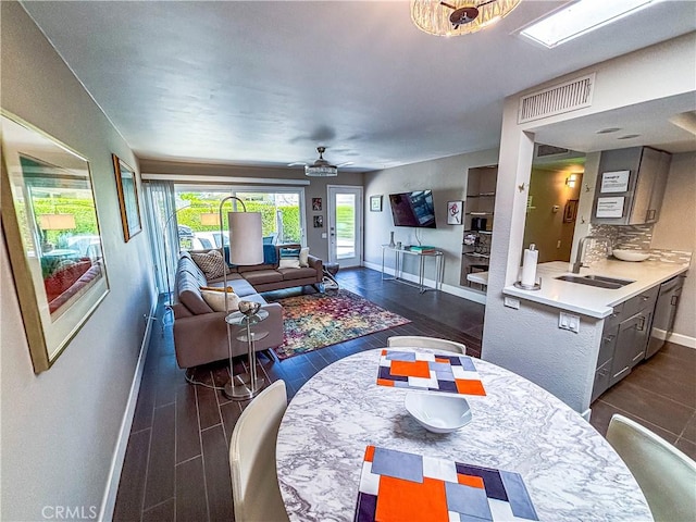 1111 E Ramon Rd Unit 37, Palm Springs, CA 92264 - dining area with a ceiling fan, healthy amount of natural light, and dark wood finished floors