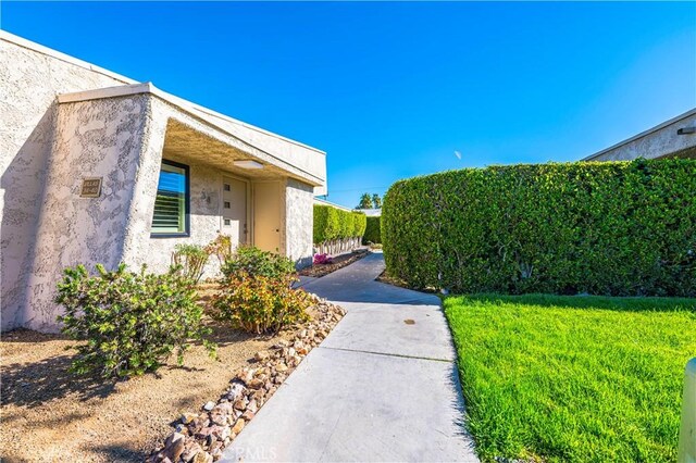 1111 E Ramon Rd Unit 37, Palm Springs, CA 92264 - view of side of home featuring stucco siding