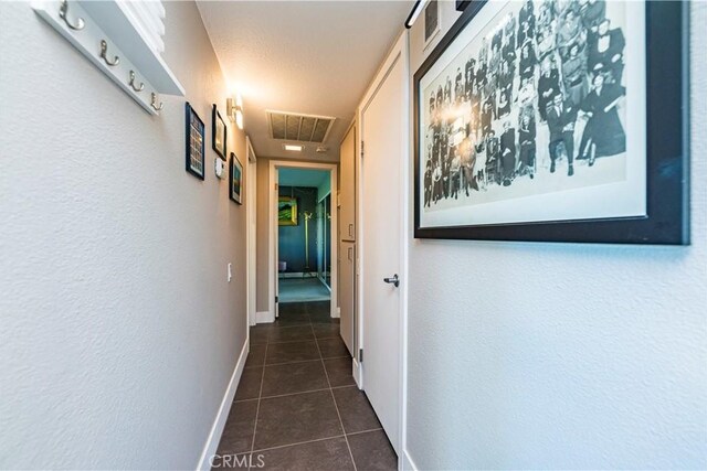 1111 E Ramon Rd Unit 37, Palm Springs, CA 92264 - hall featuring dark tile patterned floors and attic access