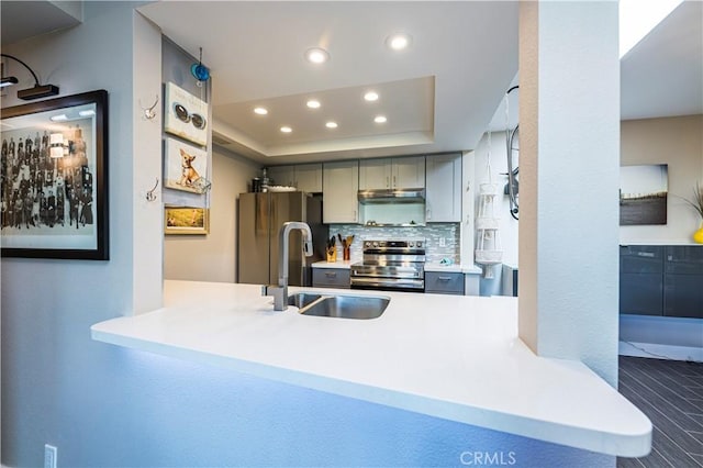 1111 E Ramon Rd Unit 37, Palm Springs, CA 92264 - kitchen with stainless steel appliances, recessed lighting, gray cabinetry, a raised ceiling, and decorative backsplash