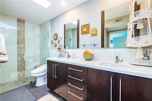 1111 E Ramon Rd Unit 37, Palm Springs, CA 92264 - full bath with a shower stall, double vanity, tile patterned floors, and wainscoting