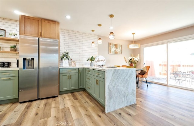 10113 Dorset, Rancho Cucamonga, CA 91730 - kitchen featuring stainless steel refrigerator with ice dispenser, green cabinetry, a peninsula, light wood-style floors, and backsplash