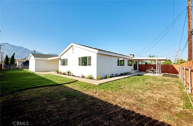 10113 Dorset, Rancho Cucamonga, CA 91730 - view of side of home featuring a fenced backyard, a mountain view, stucco siding, and a patio area
