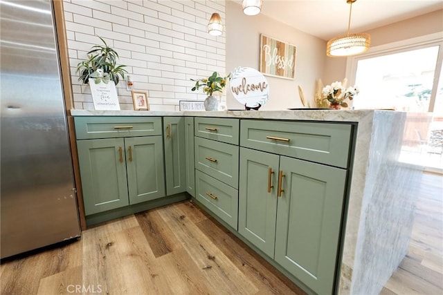 10113 Dorset, Rancho Cucamonga, CA 91730 - kitchen featuring green cabinets, stainless steel refrigerator, light countertops, light wood-style flooring, and decorative light fixtures