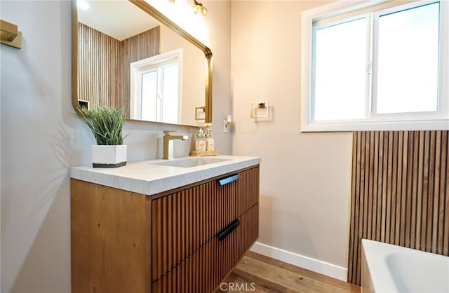 10113 Dorset, Rancho Cucamonga, CA 91730 - bathroom with vanity, a tub, and wood finished floors