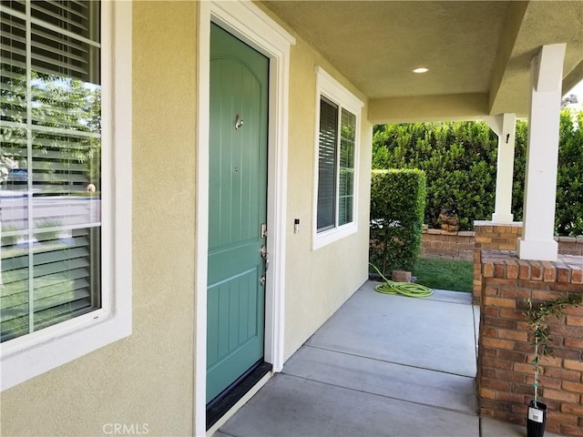 102 Mesa Ct, Calimesa, CA 92320 - property entrance featuring a porch and stucco siding