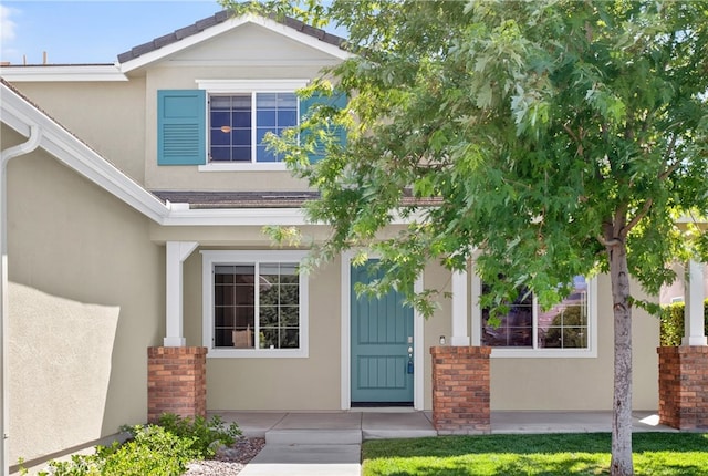 102 Mesa Ct, Calimesa, CA 92320 - view of exterior entry with stucco siding and brick siding
