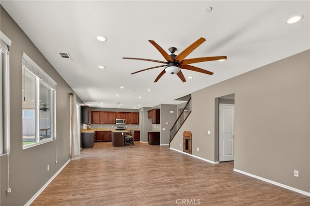 102 Mesa Ct, Calimesa, CA 92320 - unfurnished living room featuring recessed lighting, ceiling fan, light wood finished floors, and stairway