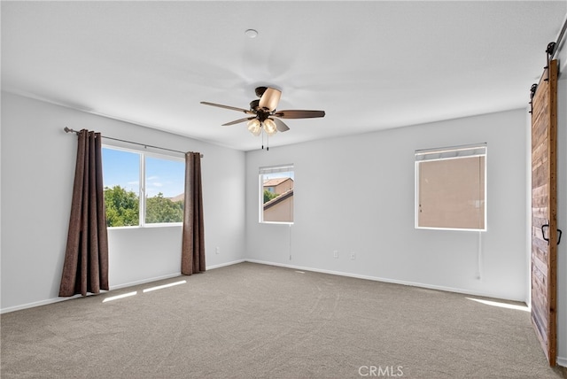 102 Mesa Ct, Calimesa, CA 92320 - empty room with a barn door, carpet, and ceiling fan