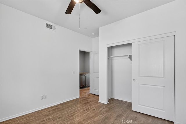 102 Mesa Ct, Calimesa, CA 92320 - unfurnished bedroom with wood finished floors, a closet, and a ceiling fan
