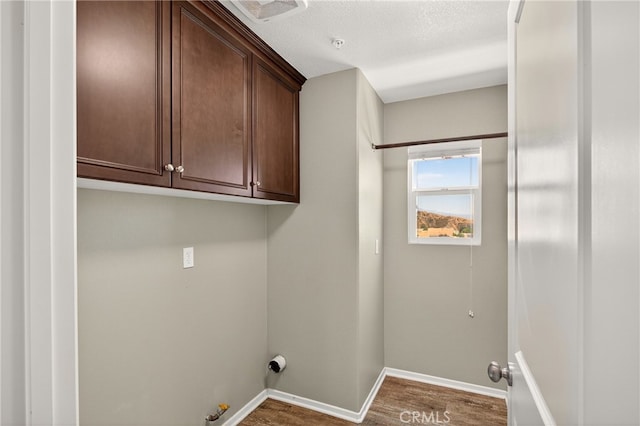 102 Mesa Ct, Calimesa, CA 92320 - washroom with hookup for a gas dryer, cabinet space, and dark wood-style flooring
