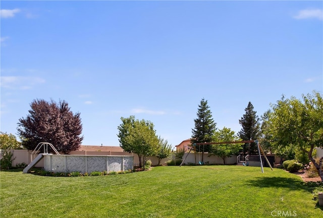 102 Mesa Ct, Calimesa, CA 92320 - fenced backyard with a playground