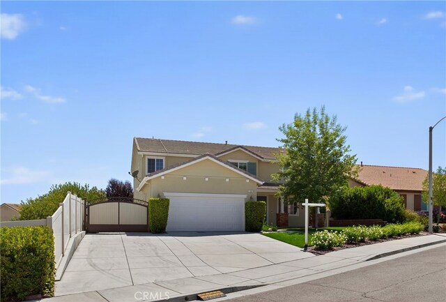 102 Mesa Ct, Calimesa, CA 92320 - view of front of house featuring a gate, a garage, concrete driveway, and stucco siding