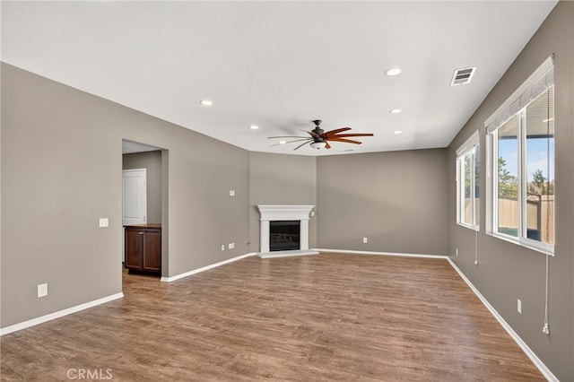 102 Mesa Ct, Calimesa, CA 92320 - unfurnished living room with a ceiling fan, recessed lighting, wood finished floors, and a glass covered fireplace