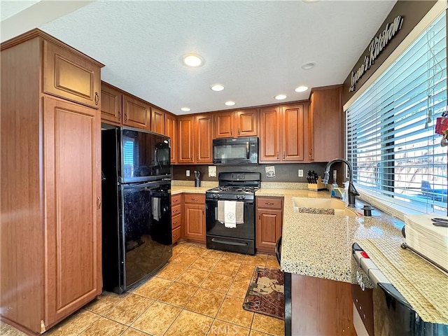 11700 White Pine Ct, Fontana, CA 92337 - kitchen with black appliances, recessed lighting, light tile patterned floors, light stone countertops, and brown cabinetry